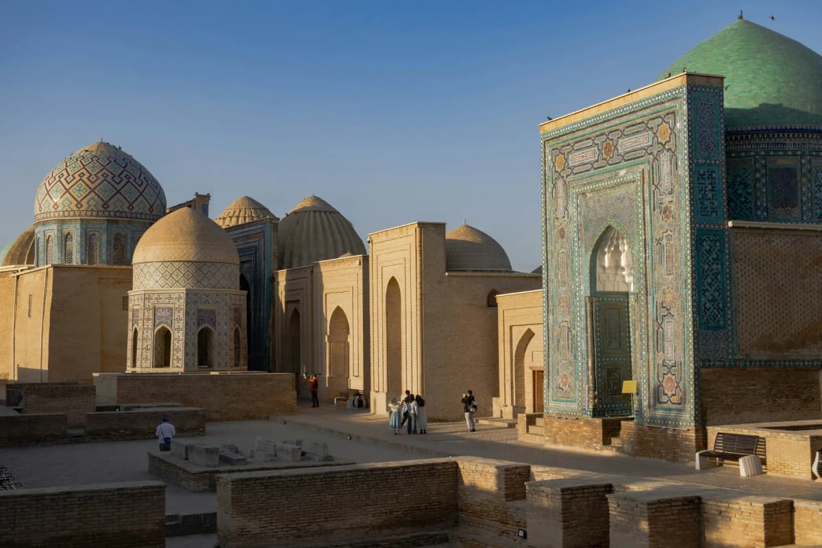 Tiled mausoleums and domes lining the avenue of Shah-i-Zinda necropolis in Samarkand in early morning light
