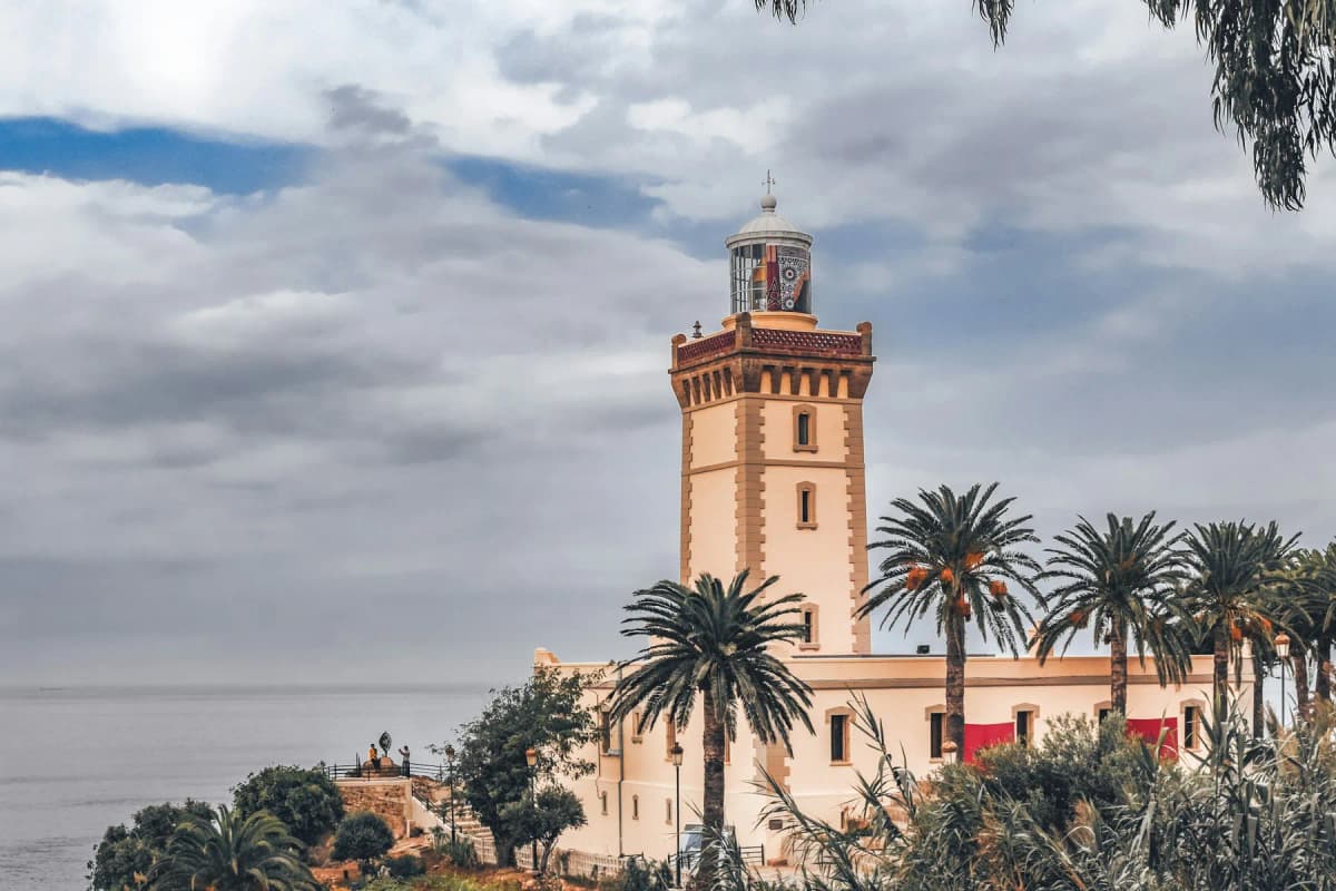 The lighthouse at Cap Spartel near Tangier, surrounded by palm trees above the sea