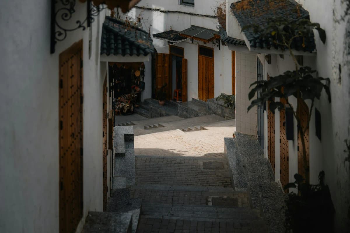 A quiet stepped lane with wooden doors and white walls in the kasbah of Tangier
