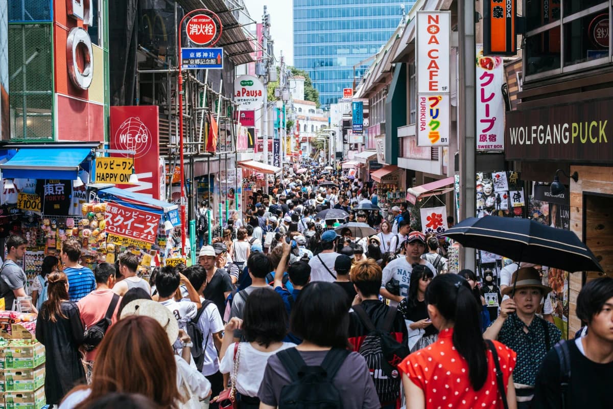 Crowds filling Takeshita Street in Harajuku, Tokyo, lined with colourful shop signs
