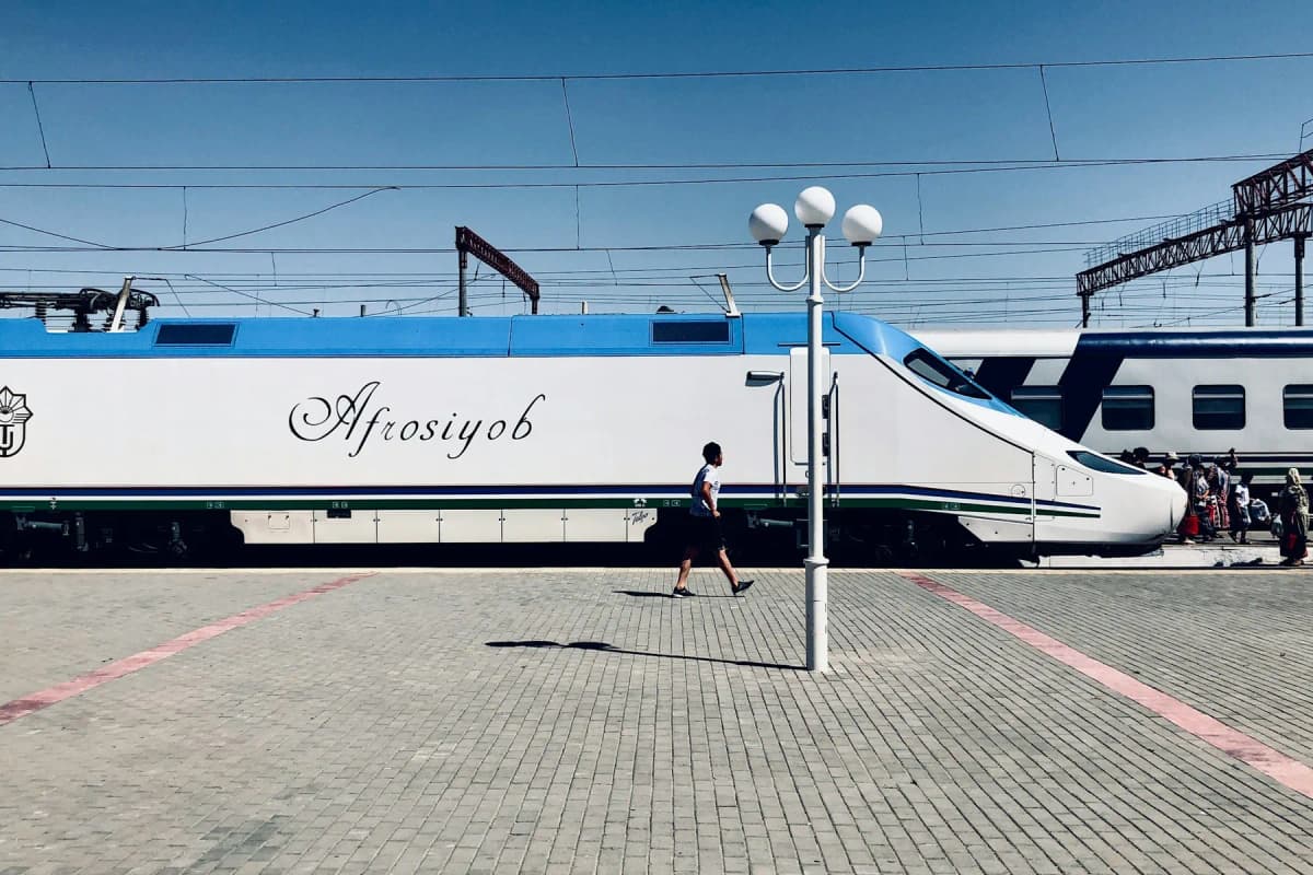 Uzbekistan itinerary: an Afrosiyob high-speed train waiting at a station platform in Uzbekistan