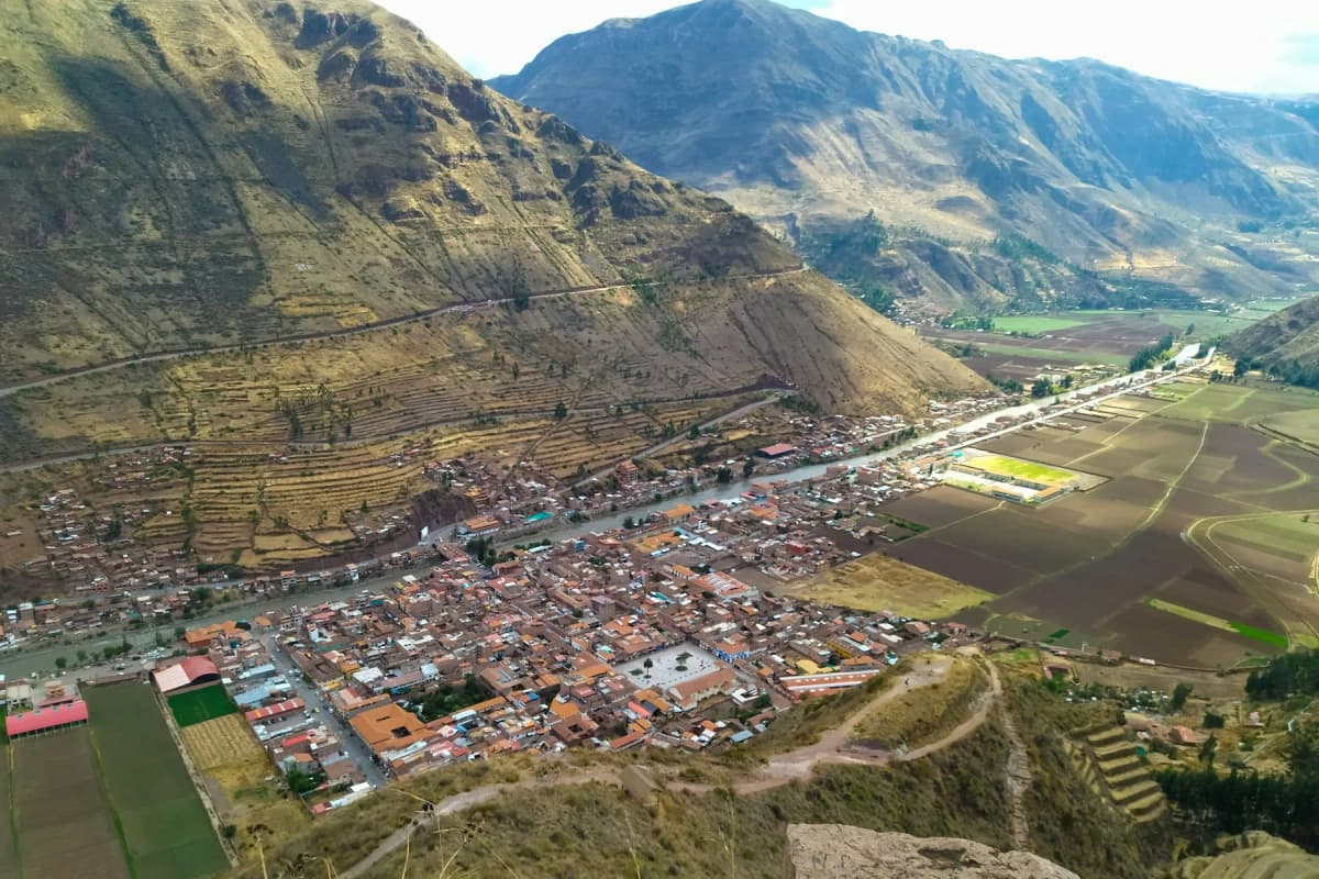 The town of Pisac in the Sacred Valley, with terraced hills rising behind it