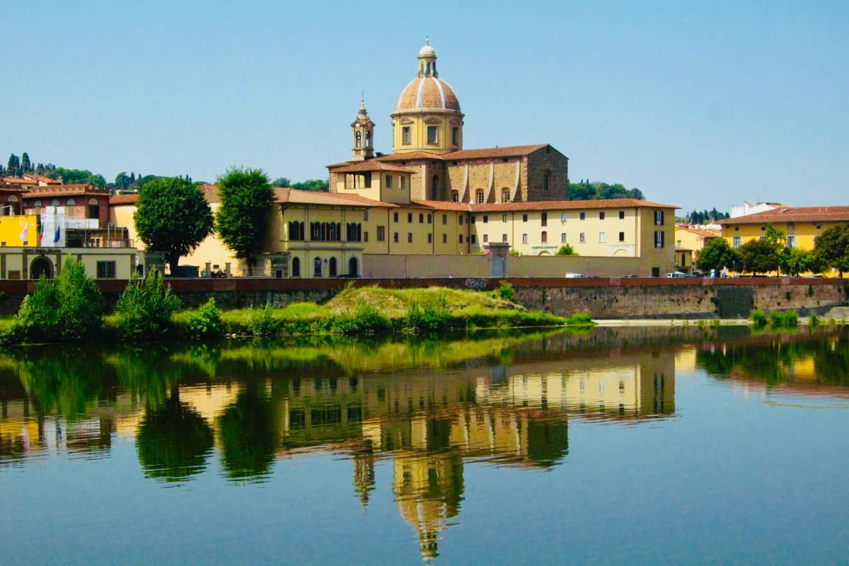 The domed church of San Frediano in Cestello reflected in the River Arno in Florence