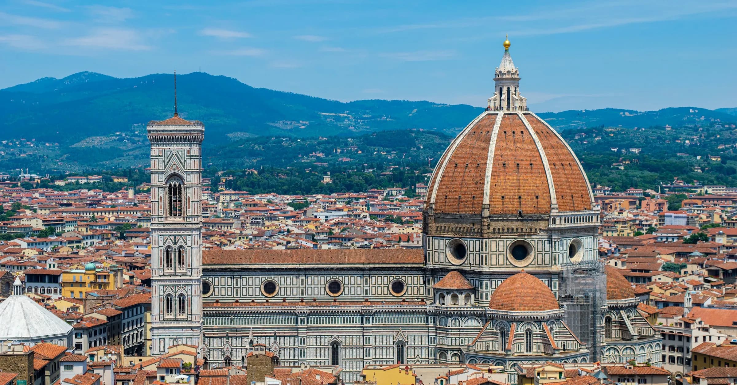 Where to stay in Florence: the cathedral dome and bell tower rising above the city's terracotta rooftops