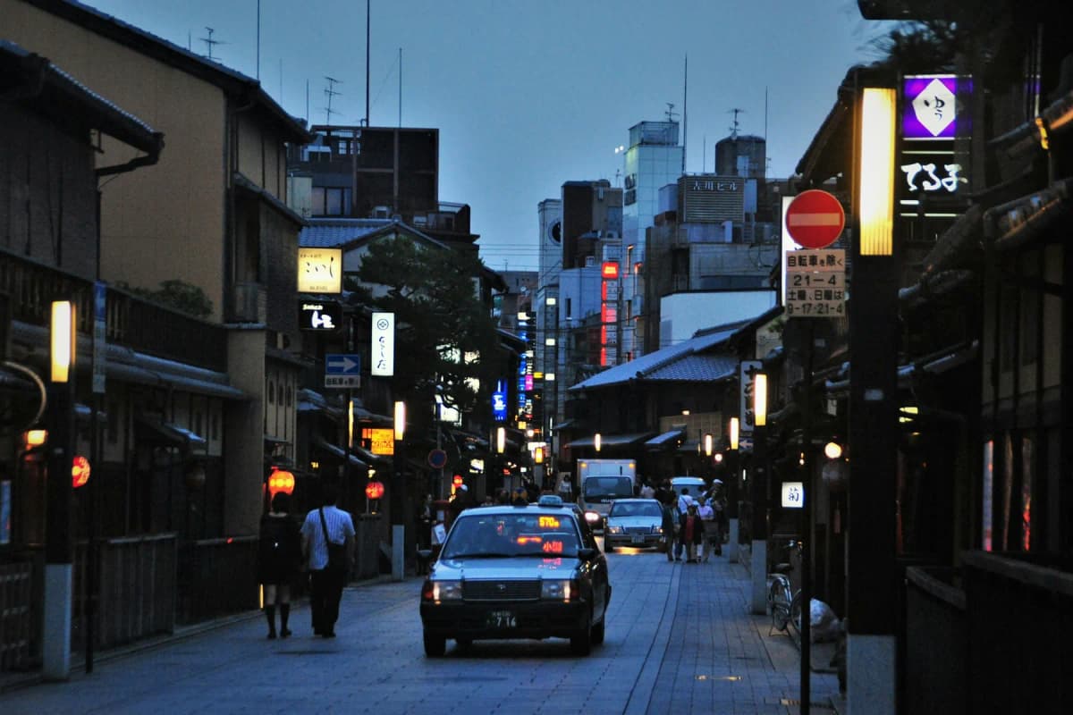 A street of traditional wooden buildings in Gion, Kyoto, at dusk