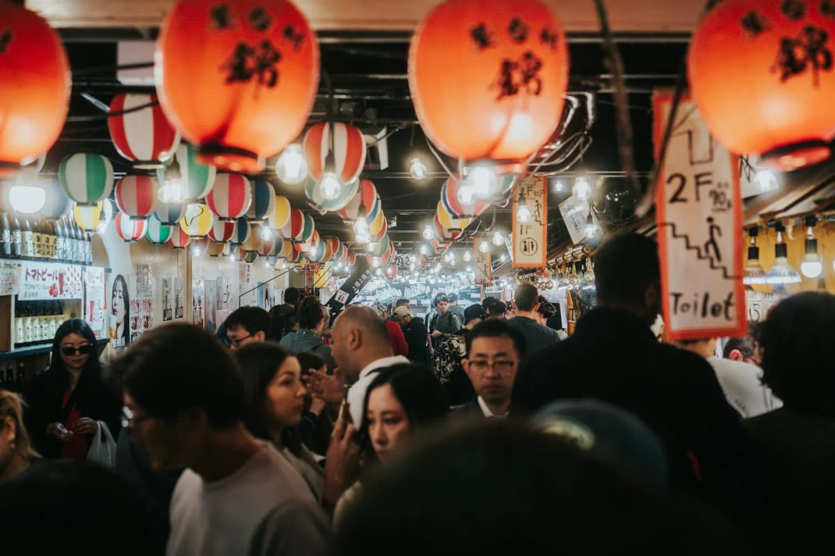 Red lanterns and crowds in Nishiki Market in downtown Kyoto