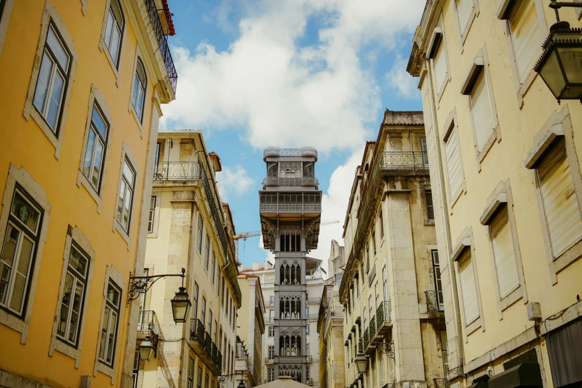 The Santa Justa Lift rising between yellow buildings in central Lisbon