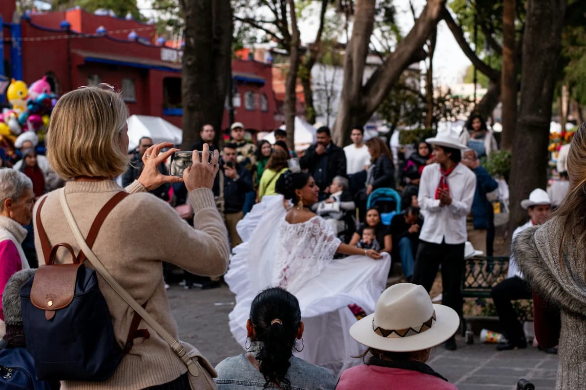Folk dancers performing for a crowd in a plaza in Mexico City