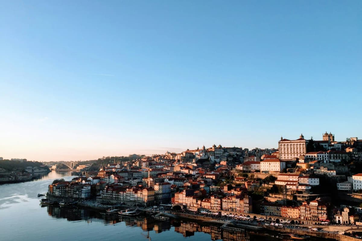 Ribeira's colourful houses reflected in the Douro river in the late-afternoon light