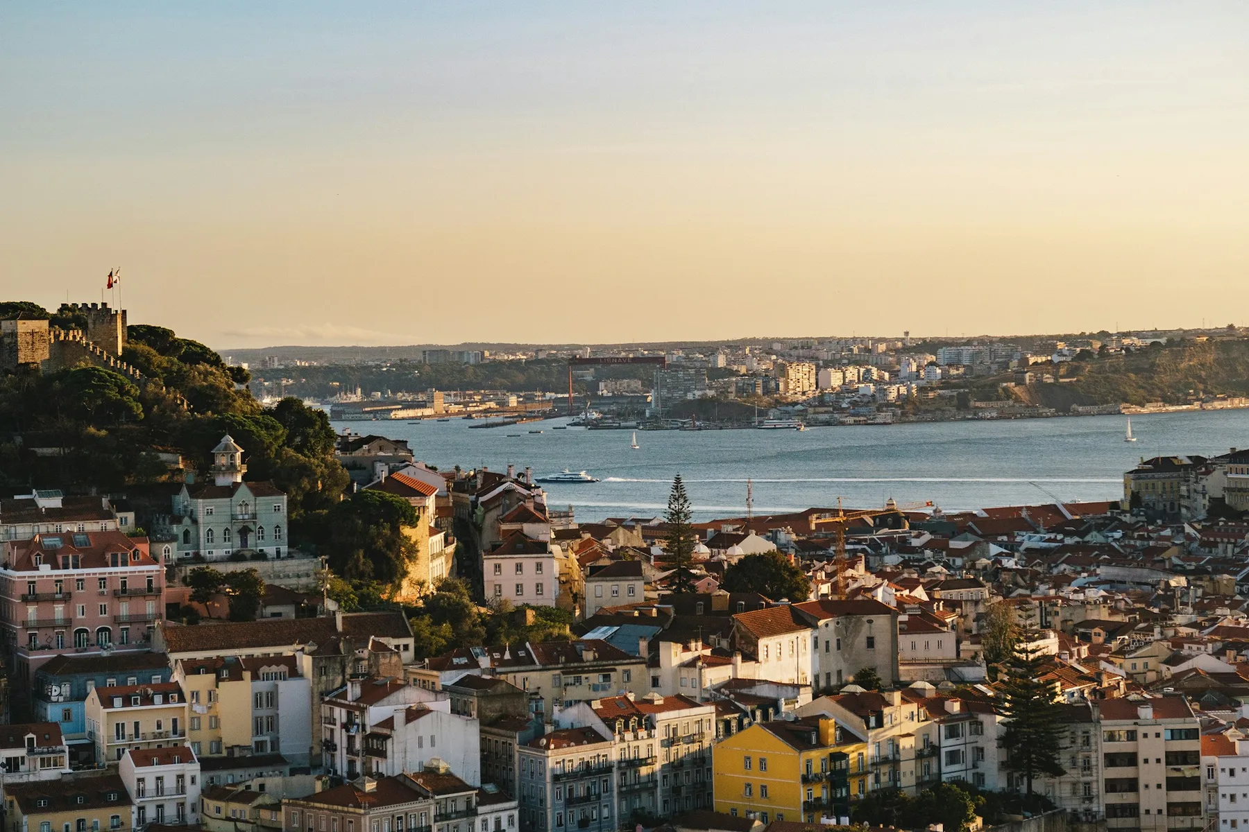 An aerial view over Lisbon's rooftops from a hillside viewpoint