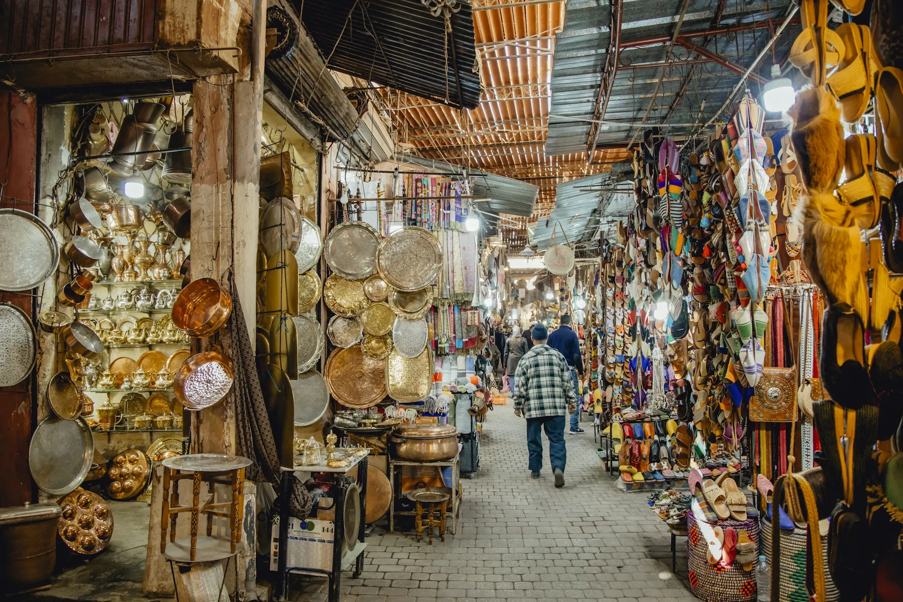 Lanterns and brass lamps hanging in a covered souk in the Marrakech medina
