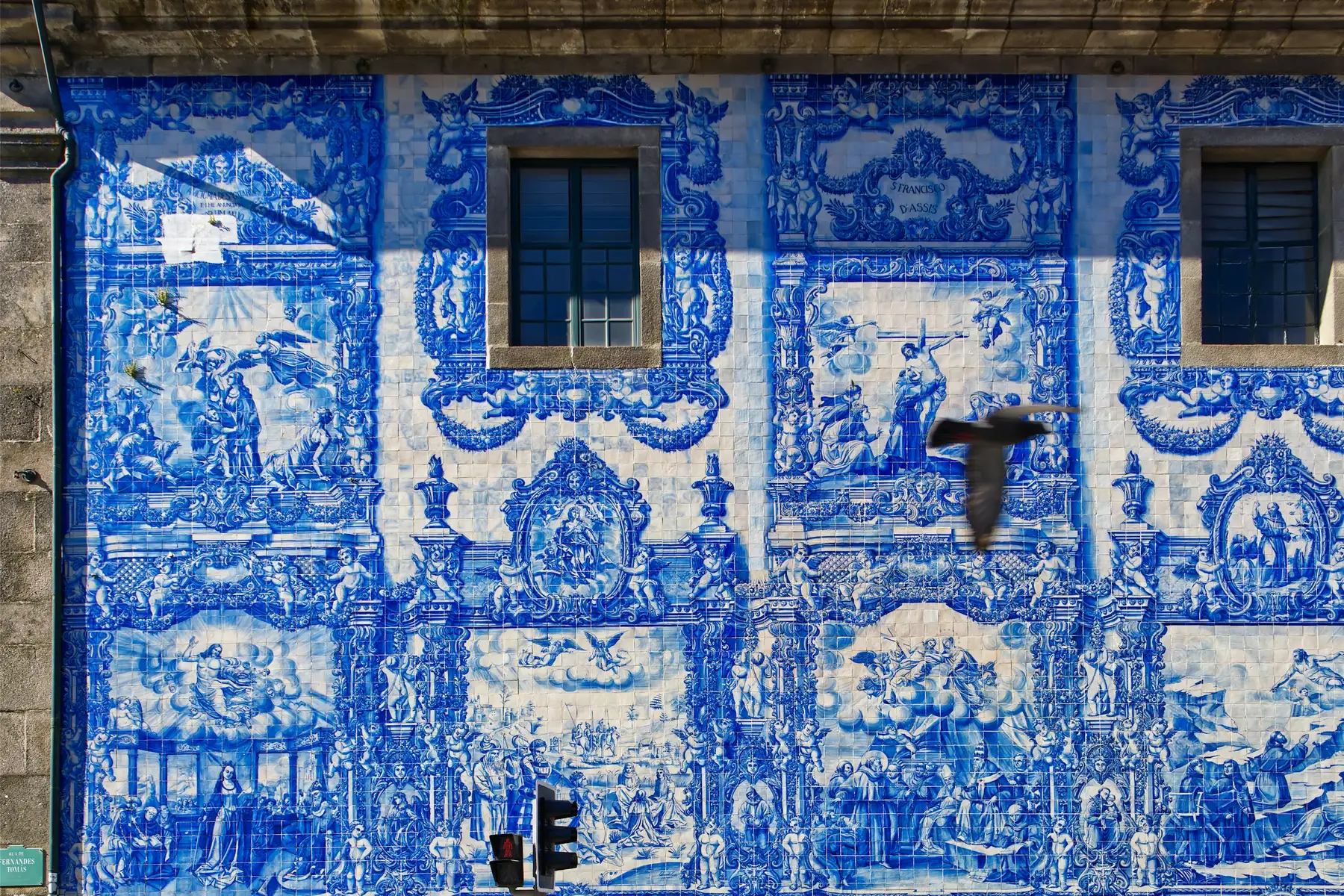 The blue and white azulejo-tiled façade of the Capela das Almas church on Rua de Santa Catarina in Porto