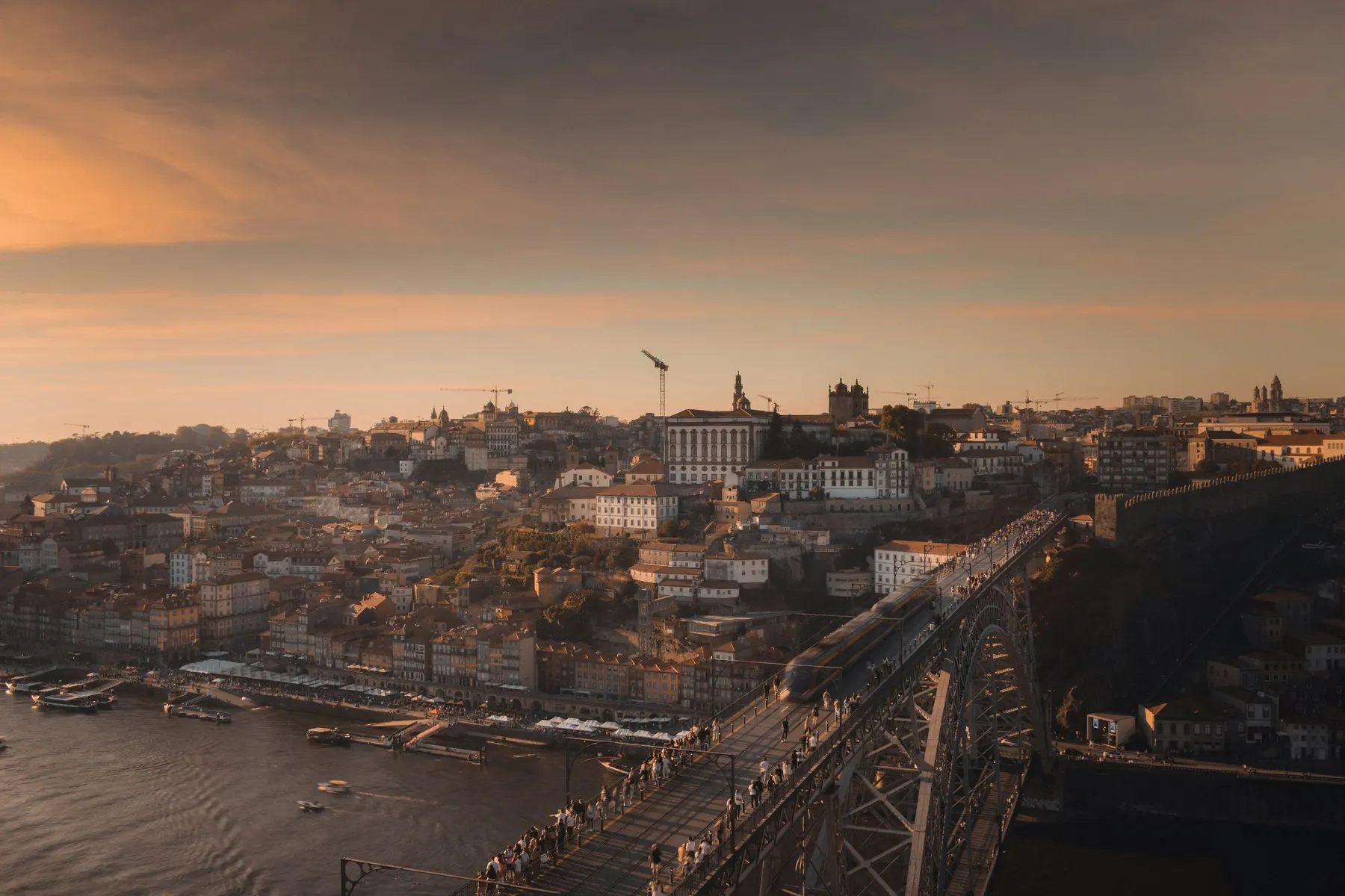 Sunset over Porto's rooftops and the upper deck of the Dom Luís I bridge, seen from Vila Nova de Gaia